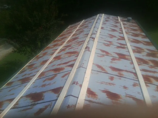 Rusted metal roof panels with new wood purlins before replacement — Storm Damage Roof Repair in Twinsburg by Roofing Brothers