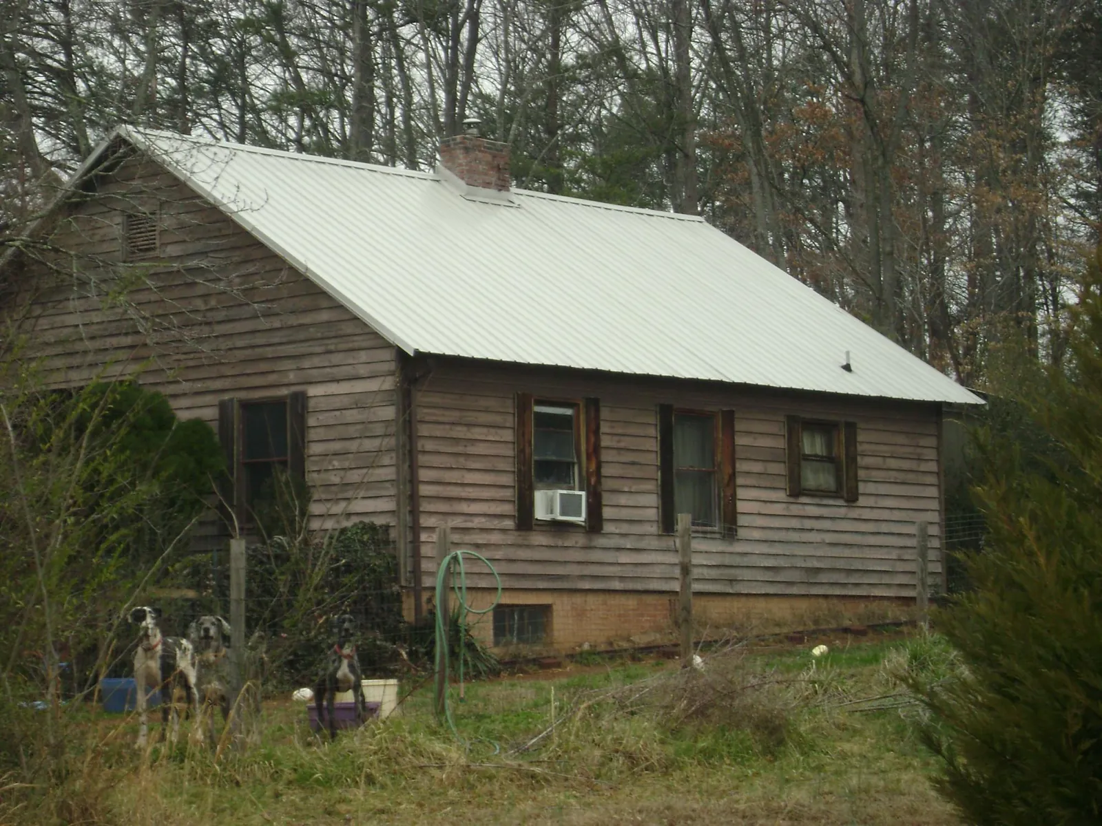 White metal roof on an old wood sided farmhouse, from a Metal Roof Installation job in Twinsburg